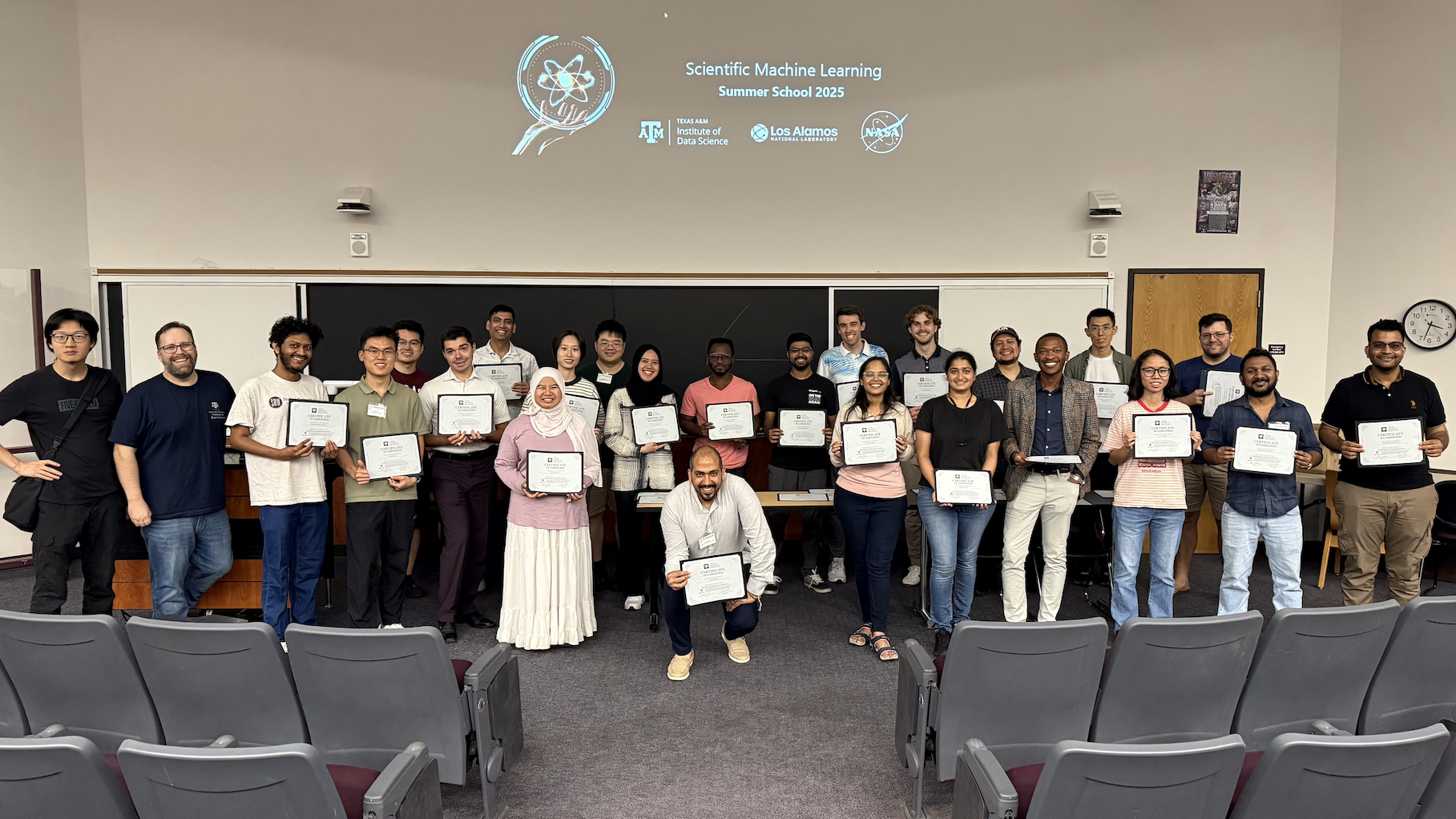 Group photo of students with certificates of completion.